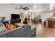 Open-concept living room features a gray sectional, modern furnishings, and seamless flow to the kitchen and dining area at 2823 E Charlotte Dr, Phoenix, AZ 85024