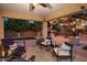 Comfortable covered patio with stylish seating, string lights, and a view of the backyard with a fireplace at 2823 E Charlotte Dr, Phoenix, AZ 85024