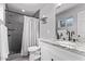 Bathroom featuring a sleek shower with gray tile and a vanity with granite countertop at 3323 N 28Th St, Phoenix, AZ 85016