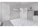 Neutral bedroom features a comfortable bed and adjacent TV and built in closet at 3323 N 28Th St, Phoenix, AZ 85016