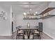 Stylish dining room with a modern chandelier, bar shelves, and seating for six at 3323 N 28Th St, Phoenix, AZ 85016