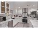 Well-lit kitchen features white cabinets, subway tile backsplash, quartz countertops, and stainless steel appliances at 3323 N 28Th St, Phoenix, AZ 85016