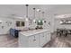 Open-concept kitchen with island seating, dining area, and comfortable living room at 3323 N 28Th St, Phoenix, AZ 85016
