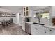 Bright kitchen features stainless steel appliances, quartz countertops, white cabinetry, and wood look floors at 3323 N 28Th St, Phoenix, AZ 85016