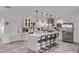 Spacious kitchen features white cabinets, quartz countertops, stainless appliances, and center island with bar stool seating at 3323 N 28Th St, Phoenix, AZ 85016