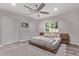 Bright bedroom with a wooden bed frame, neutral carpet, and a view of the outdoors at 3323 N 28Th St, Phoenix, AZ 85016