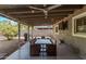 Inviting outdoor patio features a dining table, grill, ceiling fan, and ambient string lights, ideal for entertaining at 3323 N 28Th St, Phoenix, AZ 85016