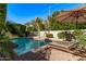 Backyard pool area with palm trees and lounge chairs. Perfect for relaxation at 3323 N 28Th St, Phoenix, AZ 85016