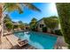 Backyard pool with lounging chairs offers a private and refreshing oasis, surrounded by mature landscaping at 3323 N 28Th St, Phoenix, AZ 85016
