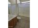 Bathroom features shower, frosted glass, sink with wood cabinets, and neutral tile floors at 3454 E Bellerive Pl, Chandler, AZ 85249