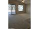 Bright living room with carpet and sliding glass doors to the patio at 3454 E Bellerive Pl, Chandler, AZ 85249