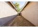 View of side yard featuring gravel, block wall, and gate at 3756 E Waite Ln, Gilbert, AZ 85295