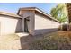The exterior view of the backyard features a sliding glass door and low maintenance landscaping at 3756 E Waite Ln, Gilbert, AZ 85295
