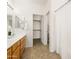 Bright bathroom featuring single sink with vanity, updated lighting, and walk in closet at 3756 E Waite Ln, Gilbert, AZ 85295