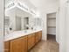 Bright bathroom featuring dual sinks with vanity, updated lighting, and a large mirror at 3756 E Waite Ln, Gilbert, AZ 85295