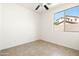 A sunlit bedroom featuring tile flooring and a window offering views of the outdoors at 3756 E Waite Ln, Gilbert, AZ 85295