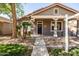 Inviting front porch with decorative columns and a cozy seating area, perfect for relaxing and enjoying the outdoors at 3756 E Waite Ln, Gilbert, AZ 85295