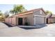 Detached garage with a two-car door and fenced access, ideal for secure parking and storage at 3756 E Waite Ln, Gilbert, AZ 85295