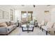 Bright living room with a plush sofa, decorative pillows, and a stylish glass-top coffee table at 3756 E Waite Ln, Gilbert, AZ 85295