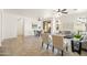Open-concept living space with a dining area, comfortable seating, and natural light from large windows at 3756 E Waite Ln, Gilbert, AZ 85295