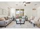 Cozy living room featuring neutral tones, two sofas, a ceiling fan and natural light at 3756 E Waite Ln, Gilbert, AZ 85295