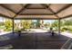A covered pavilion at the community playground with picnic tables for outdoor gatherings at 3756 E Waite Ln, Gilbert, AZ 85295