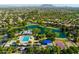 Picturesque aerial view of neighborhood amenities: lake, pool, splash pad, and basketball court at 4024 E Maplewood St, Gilbert, AZ 85297