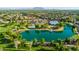 Wide aerial shot captures community amenities: pool, splash pad, lake, and a stunning mountain view at 4024 E Maplewood St, Gilbert, AZ 85297
