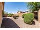 Well-kept desert backyard with gravel landscaping and shrubbery offering a serene and private outdoor space at 4024 E Maplewood St, Gilbert, AZ 85297