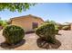 Desert landscaped backyard with trimmed bushes, rock ground cover, and privacy wall, low maintenance at 4024 E Maplewood St, Gilbert, AZ 85297