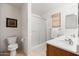 Bright bathroom featuring a double vanity and a glass-enclosed shower at 4024 E Maplewood St, Gilbert, AZ 85297