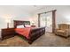 Well-lit bedroom with a large window and matching nightstands and lamps at 4024 E Maplewood St, Gilbert, AZ 85297