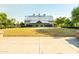 Expansive clubhouse with metal roof, stone facade, set on a manicured lawn and clear blue sky at 4024 E Maplewood St, Gilbert, AZ 85297