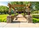 A lovely walkway leads up to the beautiful community center with benches and lush green landscaping at 4024 E Maplewood St, Gilbert, AZ 85297