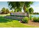 Stone sign for Ranch House Clubhouse & Park near lush landscaping and a serene water feature at 4024 E Maplewood St, Gilbert, AZ 85297