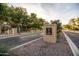 Community entrance sign surrounded by mature trees and well-maintained landscaping at 4024 E Maplewood St, Gilbert, AZ 85297