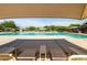 Inviting community pool featuring lounge chairs and sun shades for residents to enjoy at 4024 E Maplewood St, Gilbert, AZ 85297