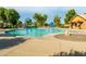 Zero entry community pool with colorful splash pad features, sunshades, and lounge chairs on a sunny day at 4024 E Maplewood St, Gilbert, AZ 85297
