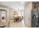 Cozy dining area with a round table and four chairs next to a refrigerator and doorway at 4024 E Maplewood St, Gilbert, AZ 85297