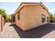 Side exterior shot of a home with tan stucco and rocks instead of grass at 4024 E Maplewood St, Gilbert, AZ 85297