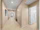 Bright hallway with neutral tones, arched doorways, and tile flooring at 4024 E Maplewood St, Gilbert, AZ 85297