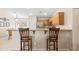Eat-in kitchen area with bar stool seating and granite countertops at 4024 E Maplewood St, Gilbert, AZ 85297