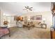 Open-concept living room with a ceiling fan and an adjacent dining area and kitchen at 4024 E Maplewood St, Gilbert, AZ 85297