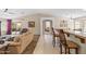 Open-concept living room with kitchen view, neutral tones, and vaulted ceiling at 4024 E Maplewood St, Gilbert, AZ 85297