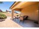 Relaxing covered patio with seating area; great backyard for entertaining with hardscape and gravel landscaping at 4024 E Maplewood St, Gilbert, AZ 85297