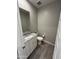 Bathroom with granite countertop, white cabinets and wood tile flooring at 4073 E Amoroso Dr, Gilbert, AZ 85296