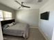 Bedroom features plush carpeting, fan and a wall-mounted television at 4073 E Amoroso Dr, Gilbert, AZ 85296