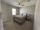 Neutral bedroom features plush carpeting, fan, window with blinds and soft furnishings on the bed at 4073 E Amoroso Dr, Gilbert, AZ 85296