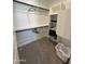 Walk-in closet with custom shelves, hanging rods, and a white plastic laundry basket at 4073 E Amoroso Dr, Gilbert, AZ 85296
