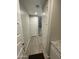 Bright hallway features gray wood-look tile floors and doors leading to other rooms and stairs at 4073 E Amoroso Dr, Gilbert, AZ 85296